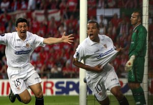 Sevilla's Luis Fabiano, center, celebrates with his teammate Marti, left, as Middlesbrough keeper Mark Schwarzer looks disappointed after Fabiano scored the opening goal during the UEFA Cup final soccer match between FC Sevilla and  Middlesbrough FC in Eindhoven, The Netherlands, Wednesday, May 10, 2006. (AP Photo/Michael Sohn)